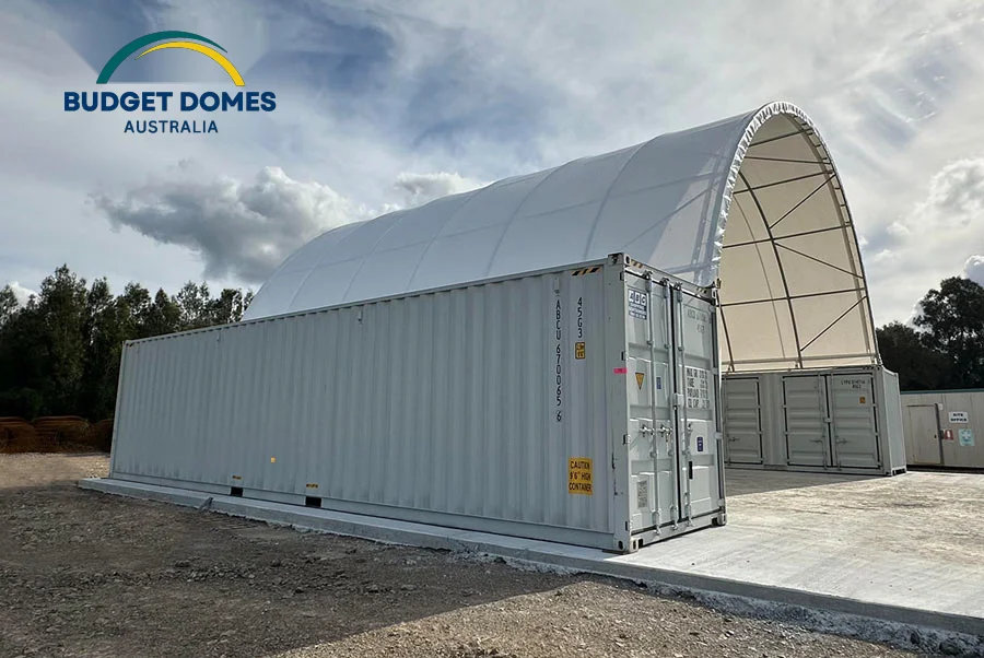 Completed white PVC container dome shelter mounted above shipping containers